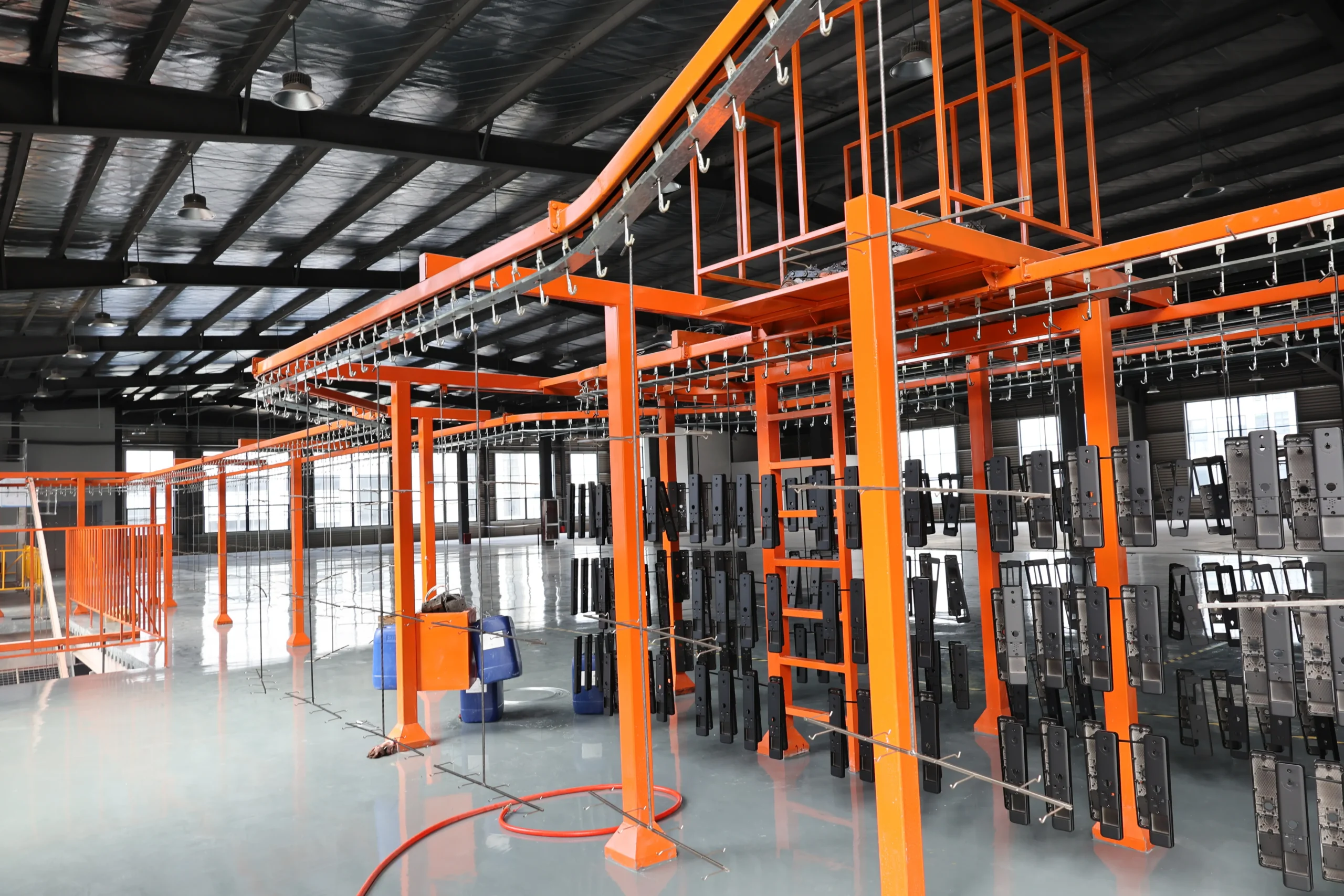 Equipment assembly area with technicians assembling spray booths and ovens