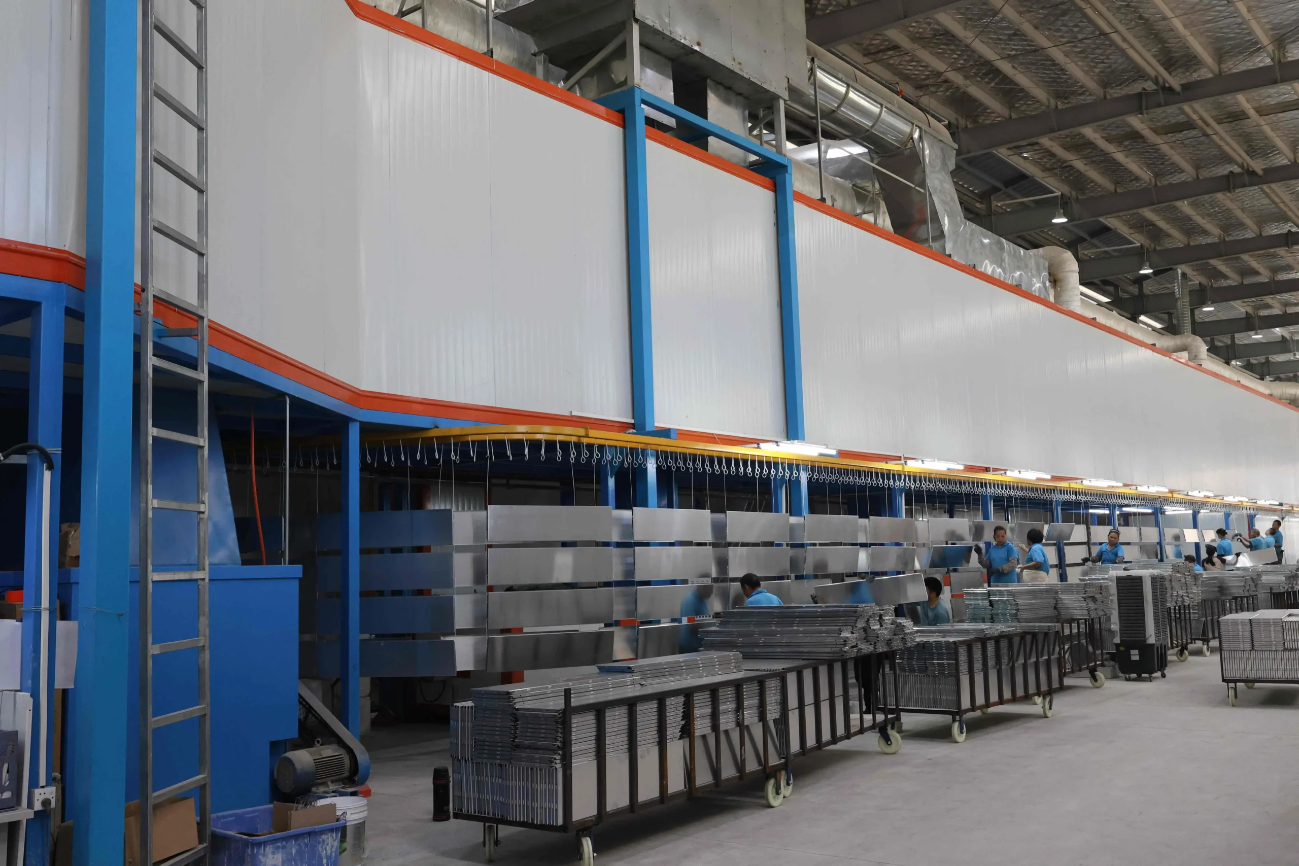 Engineer reviewing backpack type powder spraying room layout and coating booth configuration